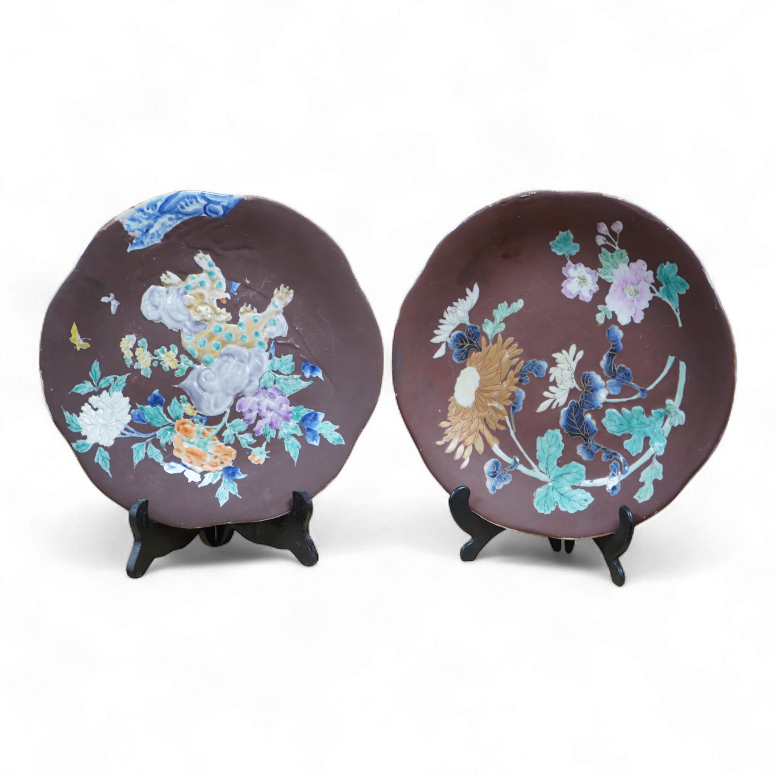 A pair of Japanese relief plates with brown glaze, 28cm high